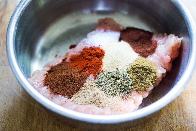 spices on ground turkey in mixing bowl.