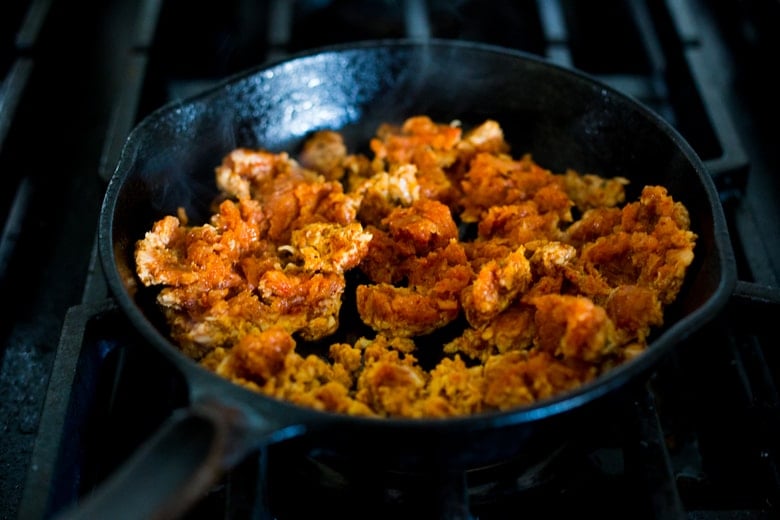 homemade Mexican chorizo browning in cast iron skillet.