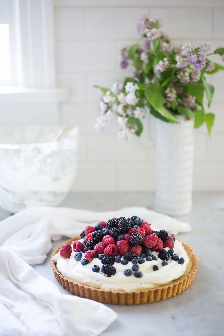 Summer Berry Tart with Shortbread Crust. A simple delicious tart recipe featuring fresh, juicy summer berries, over a lemony filling and a buttery shortbread curst. Easy, delicious! #berrytart #tart #raspberrytart #berries #freshberries #summerdessert #dessert #blackberries 