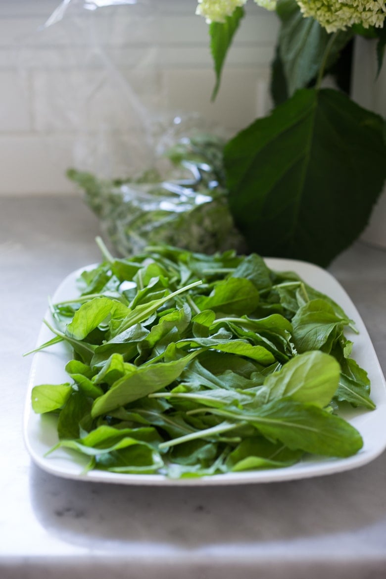 serving platter with a bed of fresh greens.