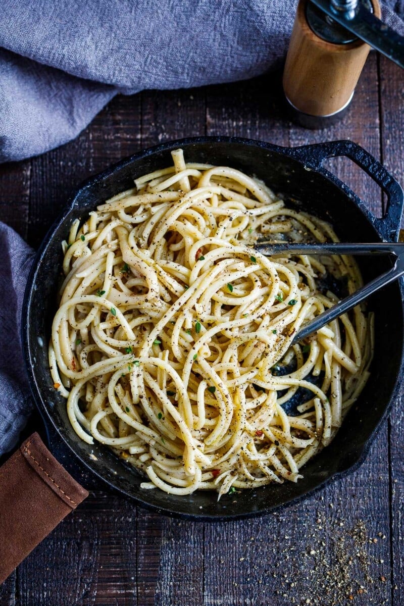 A simple, delicious recipe for Cacio e Pepe - a fast and flavorful- four-ingredient pasta recipe that can be tossed with your favorite seasonal veggie and made in 20 minutes!