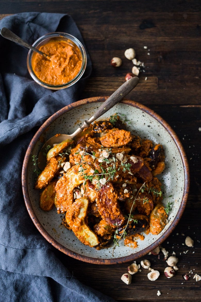 Roasted Fingerling Potatoes with Romesco Sauce, made w/ simple pantry ingredients you probably already have! A simple vegan side dish perfect for weeknight dinners or the holiday table! | www.feastingathome.com #romesco #roastedpotatoes #veganpotatoes #veganside #romescopotatoes #thanksgivingsidedish #sidedish #vegetarain 