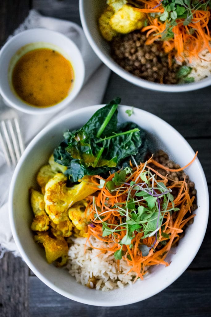 Nourish bowl: Curried cauliflower, lentils, brown rice, kale and a refreshing Carrot Slaw topped with Turmeric vinaigrette.