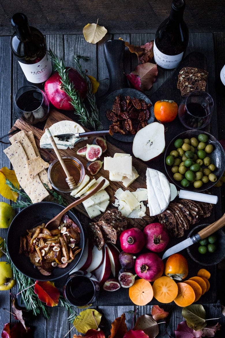 Dazzle your guests this holiday season with a beautiful Cheese Board filled with an assortment of cheese, fall fruit, honey-roasted quince, nuts, honey, olives, and crackers. Perfect for the Thanksgiving table or fall gatherings!