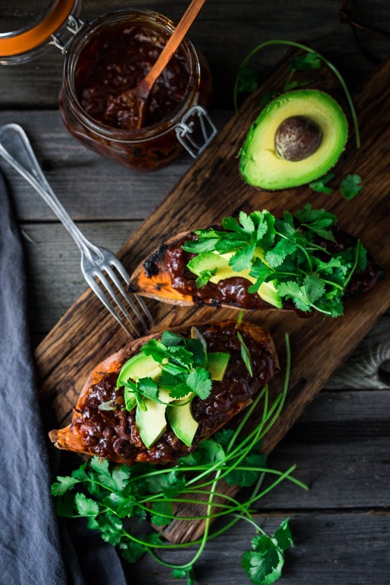 These Black Bean Stuffed Sweet Potatoes are incredibly delicious! Made with BBQ sauce, black beans  (optional chicken) melty cheese, avocado and cilantro -perfect for mixed households who have meat-lovers, vegetarians, and vegans, all living under the same roof. Vegan-adaptable and gluten-free.