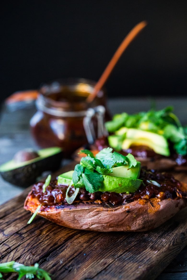 These Black Bean Stuffed Sweet Potatoes are incredibly delicious! Made with BBQ sauce, black beans  (optional chicken) melty cheese, avocado and cilantro -perfect for mixed households who have meat-lovers, vegetarians, and vegans, all living under the same roof. Vegan-adaptable and gluten-free.