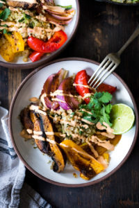 Vegan Fajita Bowls with Roasted Portobello Mushrooms and peppers served over Cilantro Lime Cauliflower Rice- a fast sheet-pan dinner that is perfect for weeknights! #fajitabowl #veganfajita #fajitas #sheetpandinner #veganbowls #buddhabowls #plantbased #cleaneating #eatclean #vegan