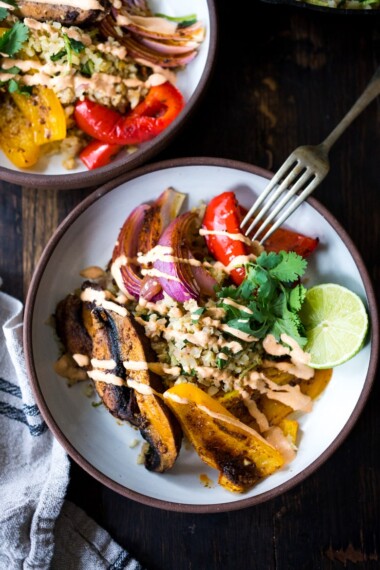 Vegan Fajita Bowls with Roasted Portobello Mushrooms and peppers served over Cilantro Lime Cauliflower Rice- a fast sheet-pan dinner that is perfect for weeknights! #fajitabowl #veganfajita #fajitas #sheetpandinner #veganbowls #buddhabowls #plantbased #cleaneating #eatclean #vegan