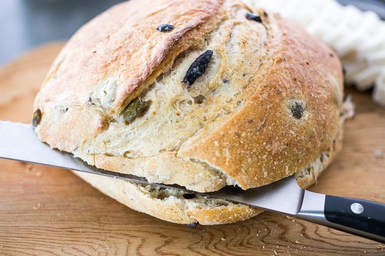 Cutting the round loaf in half.