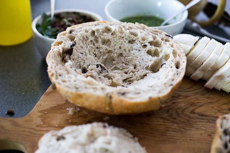 Hollowing out the round loaf of bread. 
