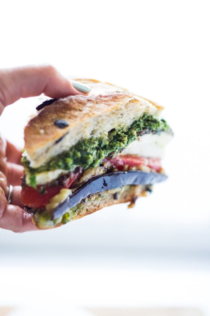 Holding a slice of Muffuletta Sandwich.