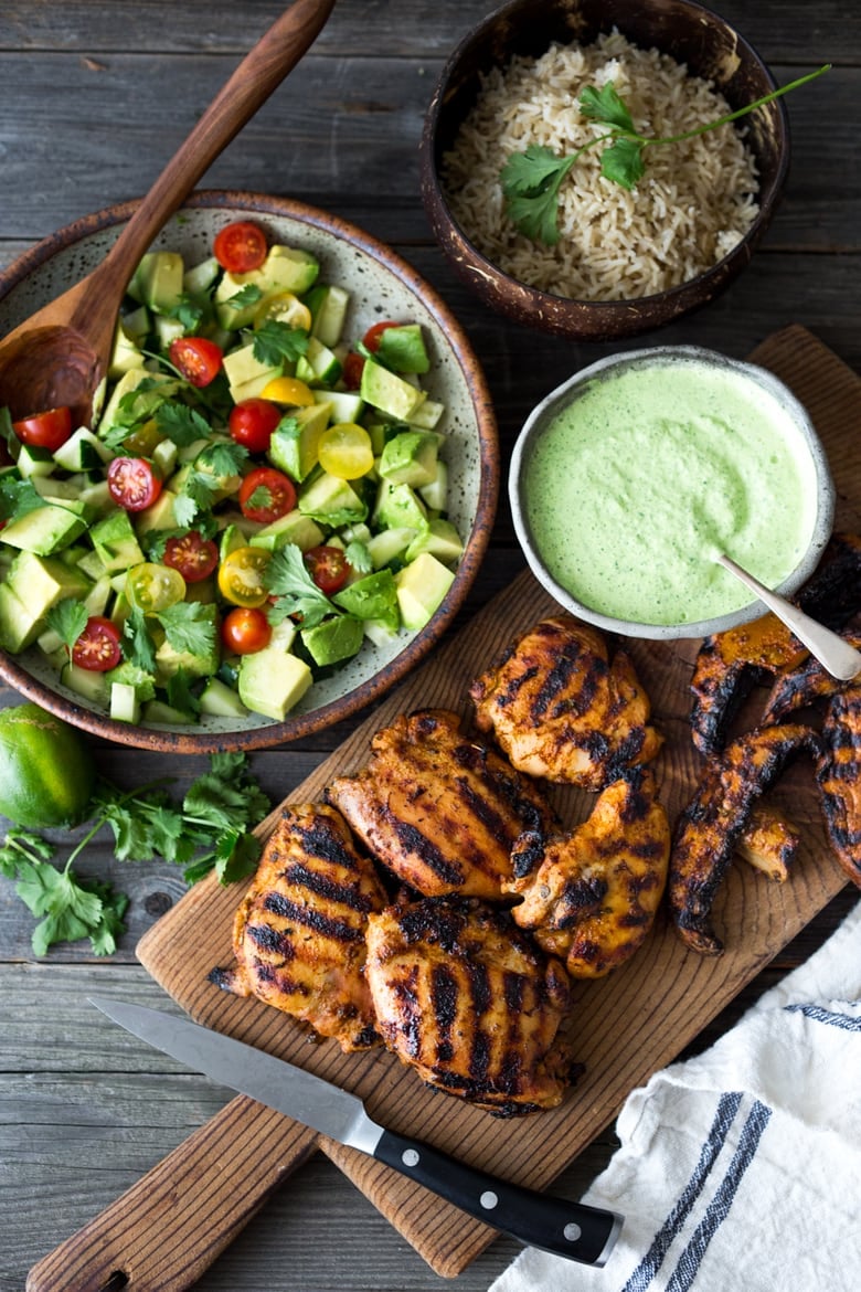 50 Grilling Recipes for Summer | Grilled Peruvian Chicken with Cilantro Sauce and Avocado Tomato Salad - or make a vegetarian version with grilled portobellos!