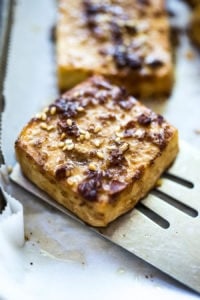 How to make Baked Tofu! A delicious source of plant-based protein perfect for salads, spring rolls, Buddha bowls, or served with a side of veggies! Vegan and Gluten-Free adaptable. | www.feastingathome.com