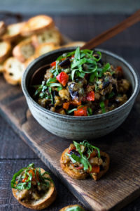 This Sicilian recipe for Eggplant Caponata- is simple, easy and full of summer flavor! Serve it as a healthy vegan appetizer over crostini, or as a delicious side dish, or turn it into an eggplant "salad" served over greens and grains! Low- Carb and Vegan! #eggplantrecipes #eggplantcaponata #caponata #feastingathome #grilledeggplant #vegan #healthy