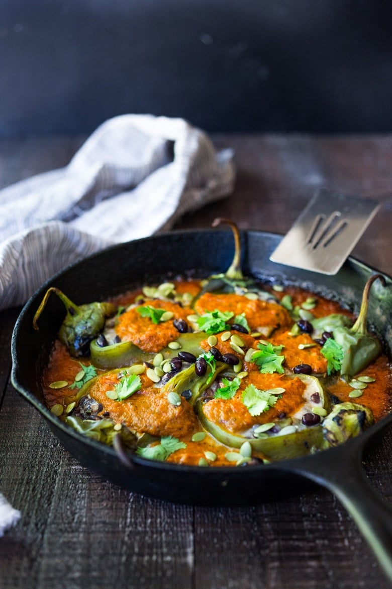 A healthy, vegan adaptable, Roasted Chiles Rellenos Recipe - that is lightened up with the addition of black beans. Simplified by roasting (instead of frying) the peppers with the Salsa Ranchero Sauce ingredients - all baked together on one sheet-pan - saving a step! #chiliesrancheros