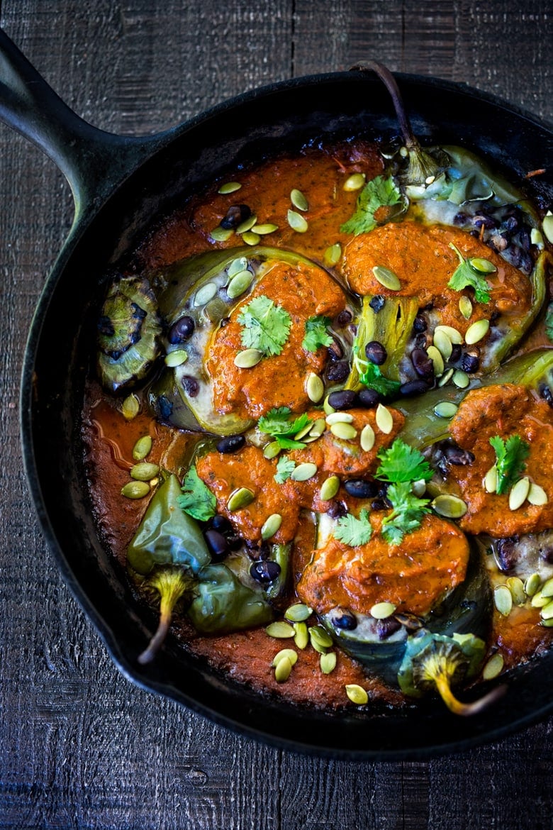 A healthy, vegan adaptable, Roasted Chiles Rellenos Recipe - that is lightened up with the addition of black beans. Simplified by roasting (instead of frying) the peppers with the Salsa Ranchero Sauce ingredients - all baked together on one sheet-pan - saving a step! #chiliesrancheros