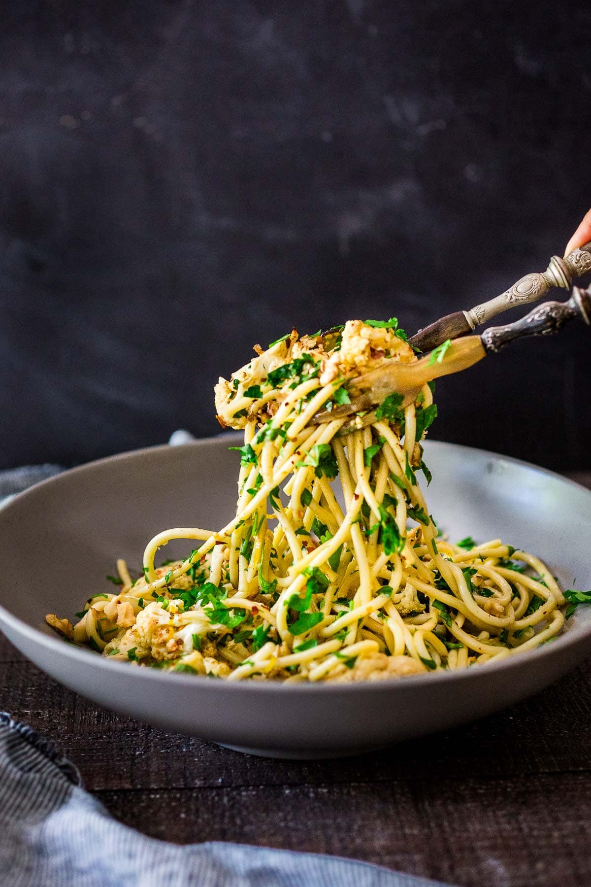 This roasted Cauliflower Pasta recipe is easy to make and completely delicious! It's made with toasted walnuts, garlic, fresh herbs and lemon zest. Video.