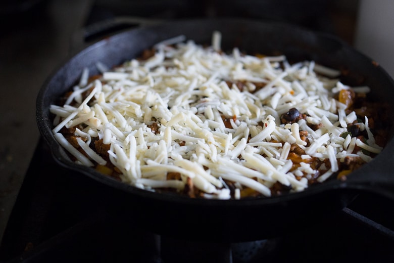 Simple Delicious Tamale Pie with your choice of ground turkey, beef or veggie meat with seasonal veggies, topped with a delicious cornbread crust. | www.feastingathome.com 