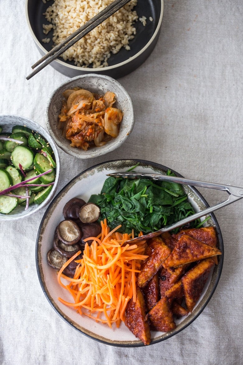 This Bibimbap recipe (aka Seoul Bowl) is made with gochujang-baked Tempeh, steamed veggies, kimchi and quick pickled cucumbers- a healthy vegan version of Bibimbap! 