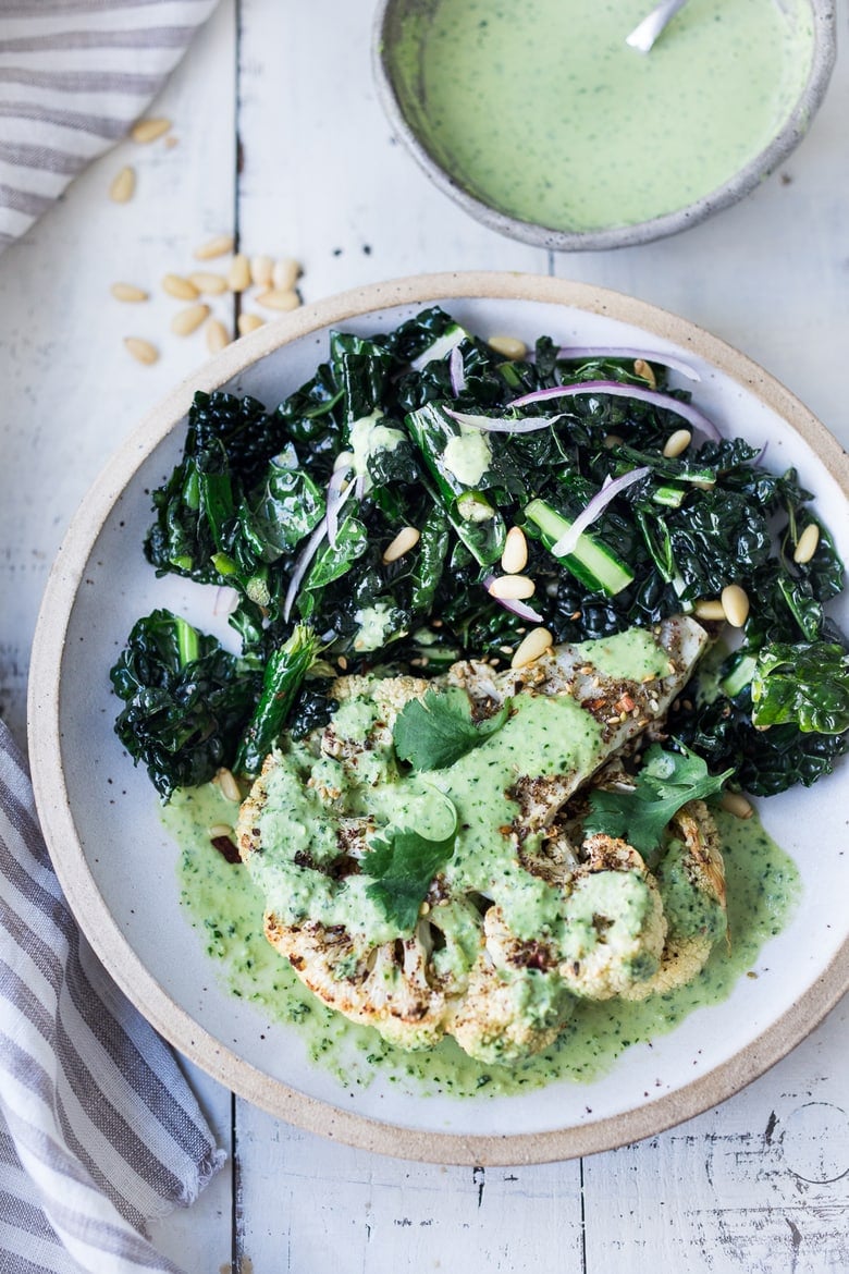 40 Mouthwatering Vegan Dinner Recipes!| Zaatar Roasted Cauliflower Steaks with Green Tahini Sauce - a simple delicious vegan meal full of Middle Eastern flavor that can be made in 35 minutes. | www.feastingathome.com