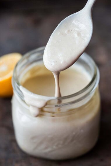 This easy tahini sauce recipe is creamy, nutty and zesty, full of punchy flavor. We love it as a salad dressing or sauce, perfect with falafel, Buddha bowls, roasted veggies and more!