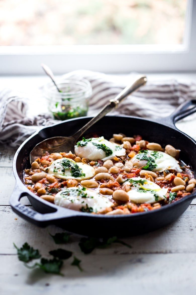 This Italian breakfast recipe is similar to one found in Tuscany. Eggs are gently poached over a savory cannellini bean and tomato stew, topped with Italian gremolata sauce. It's vegetarian. 