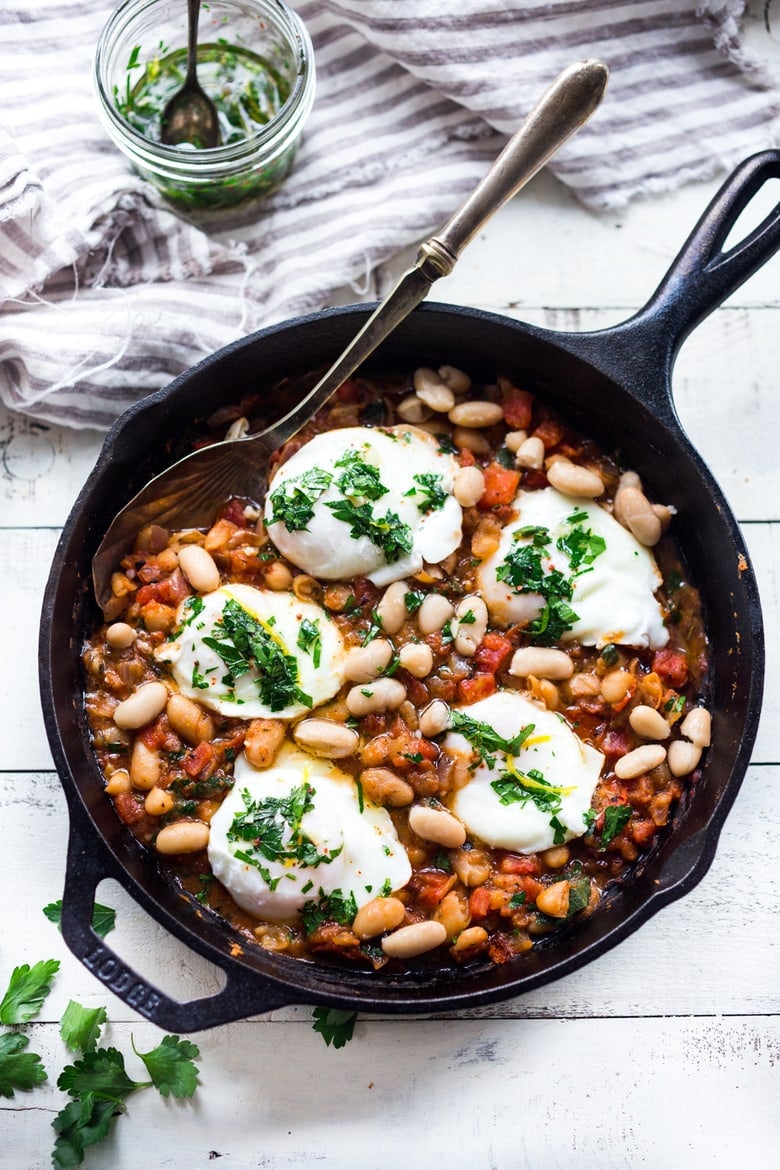 This Italian breakfast recipe is similar to one found in Tuscany. Eggs are gently poached over a savory cannellini bean and tomato stew, topped with Italian gremolata sauce. It's vegetarian. 