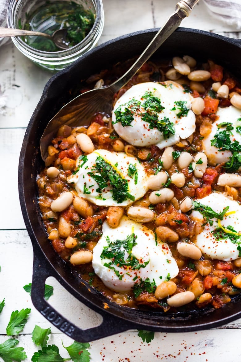 This Italian breakfast recipe is similar to one found in Tuscany. Eggs are gently poached over a savory cannellini bean and tomato stew, topped with Italian gremolata sauce. It's vegetarian. 