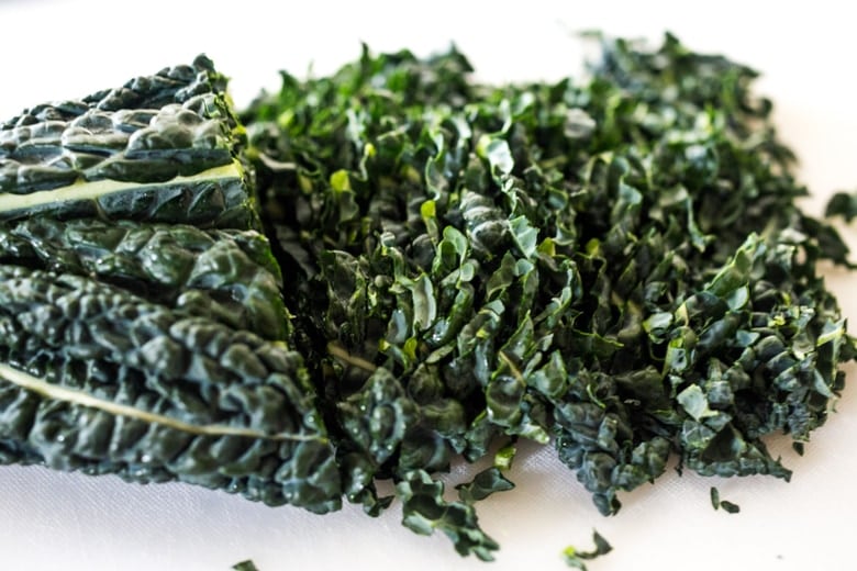 Everyday Kale Salad with simple Lemon Dressing can be made ahead, then used DAILY to top off tacos, wraps, buddha bowls, burgers, and even pizza during the week! Vegan and Gluten Free, this amazing kale slaw keeps for up to five days in the fridge. Meal Prep Savior! #kale #kalesalad #kaleslaw #mealprep #everydaysalad #kale #simplesalad | www.feastingathome.com