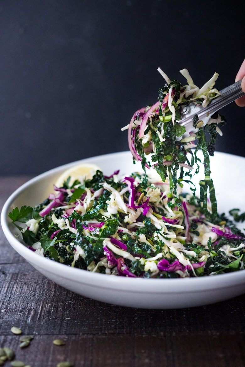 This simple Kale Slaw with Lemony Dressing can be made ahead, then used throughout the week to top off tacos, wraps, buddha bowls, burgers, and even pizza. An easy way to get in your dark leafy greens. Vegan and Gluten-Free, this amazing kale slaw keeps up to 4 days in the fridge.