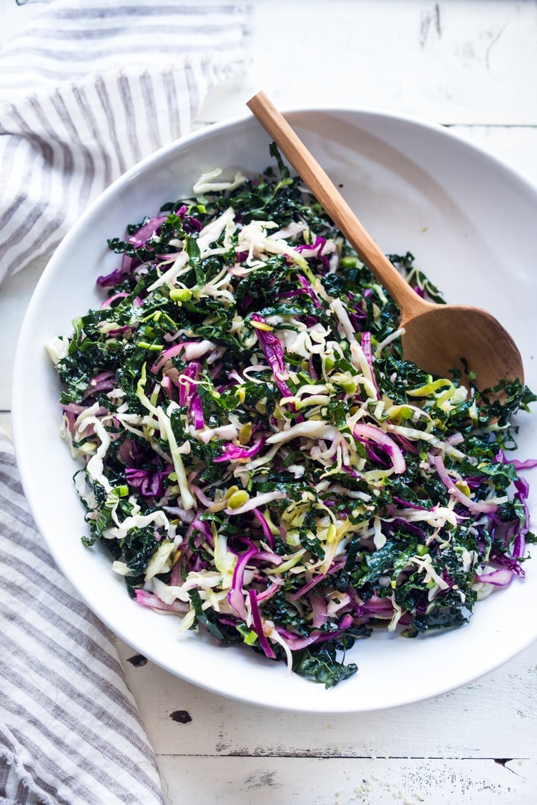 This simple Kale Slaw with Lemony Dressing can be made ahead, then used throughout the week to top off tacos, wraps, buddha bowls, burgers, and even pizza. An easy way to get in your dark leafy greens. Vegan and Gluten-Free, this amazing kale slaw keeps up to 4 days in the fridge.
