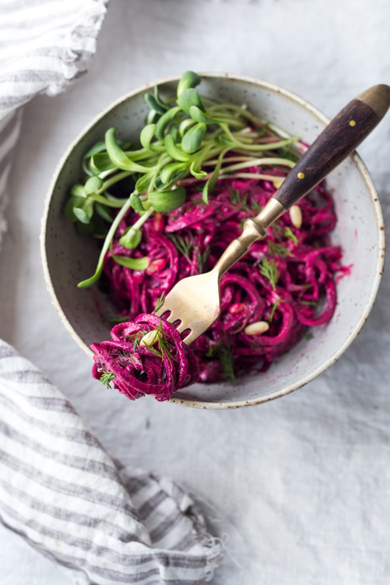 Beet Noodles in a bowl with a fork.