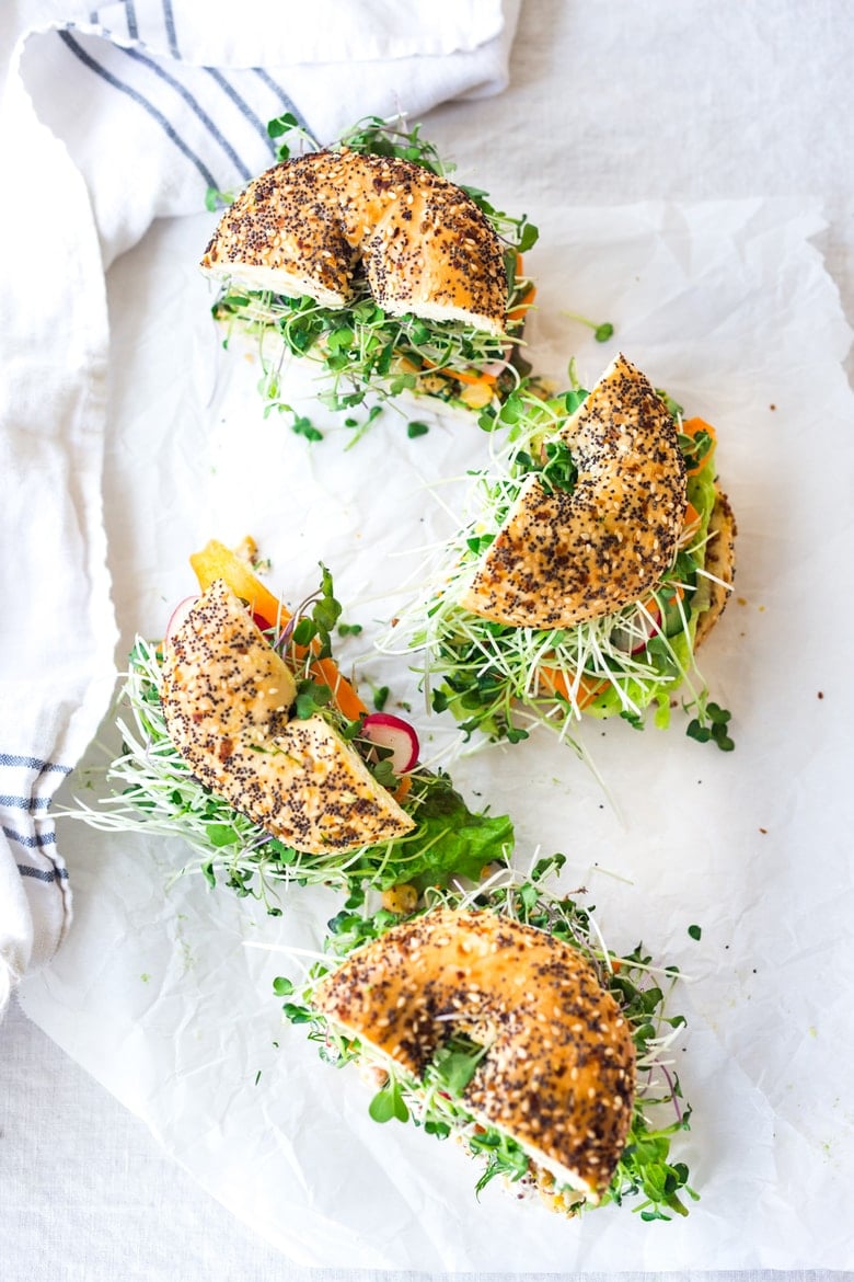 Vegan Chickpea Salad Sandwich on a bagel with microgreens and avocado. 