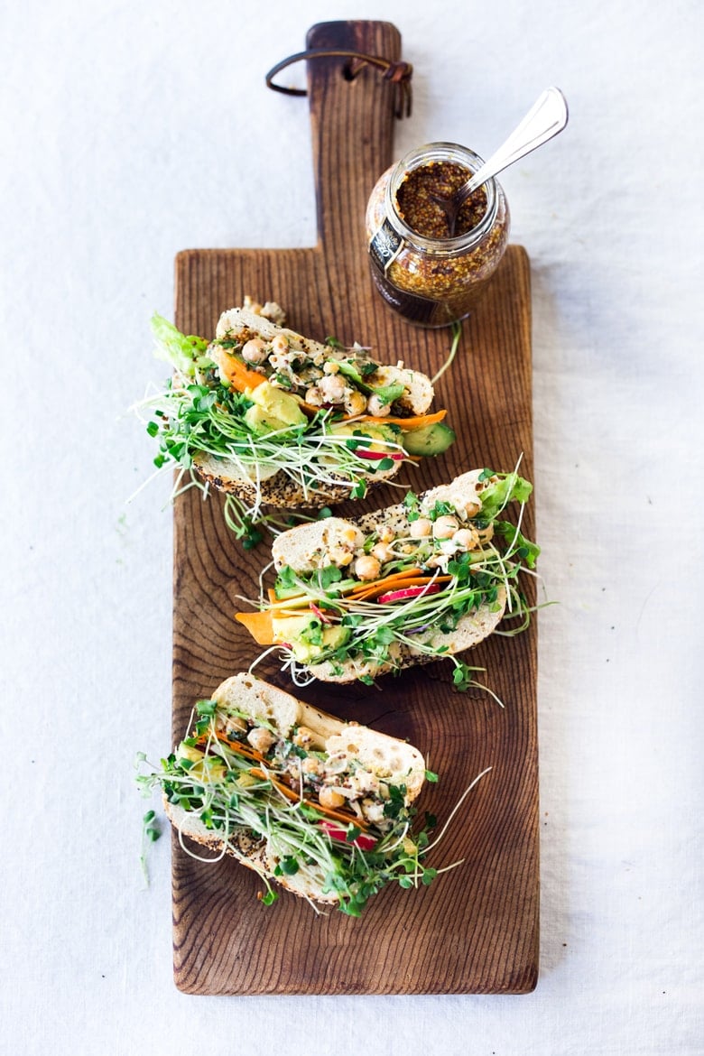 This vegan Chickpea Salad Sandwich is incredibly delcious! It's made with a herby smashed chickpea salad and layered with avocado, cucumbers, tomatoes, and microgreens. Gluten-free adaptable! Video. 