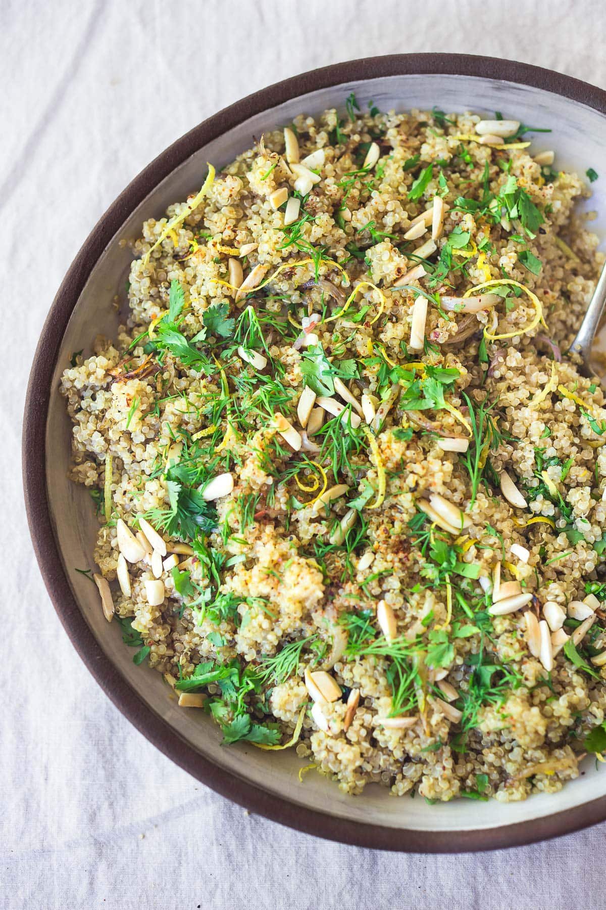 Learn how to cook perfect fluffy quinoa every time! Use in bowls, salads, wraps, or make our herby quinoa side dish. Vegan & gluten-free.