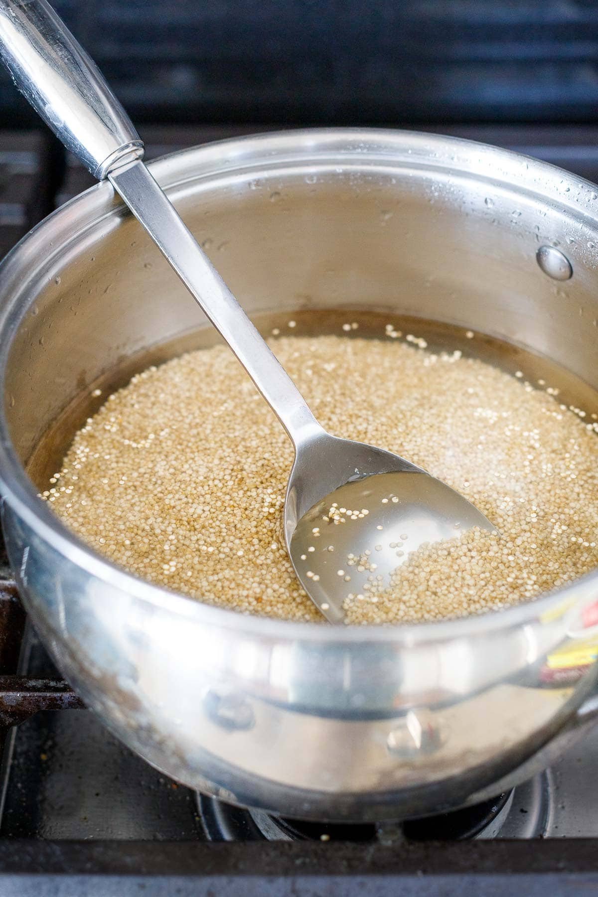 Bringing the quinoa to a boil in a medium pot.