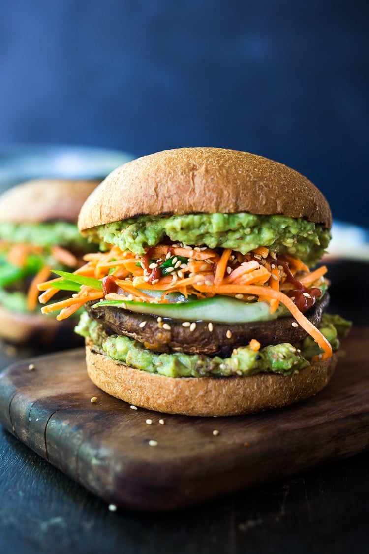 40 Mouthwatering Vegan Dinner Recipes!|This Asian-style, grilled, vegan portobello mushroom burger is full of delicious umami flavor! It's lathered with Asian-style Guacamole, topped with a cool cucumber ribbon salad and crunchy carrot slaw. Healthy, delicious and really satisfying. AND totally vegan! #veganburger #portobelloburger #veganportobelloburger #portobellomushroomrecipes #portobello #vegan #veganburger #grilled #grilledportobello