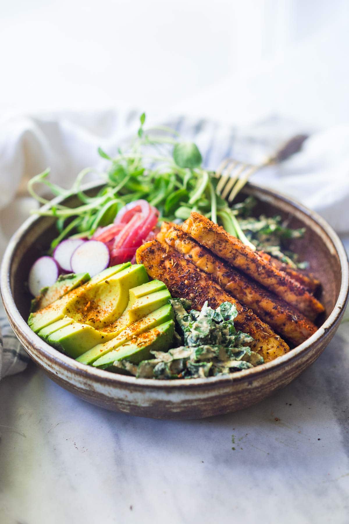 Cajun tempeh salad with kale and avocado.