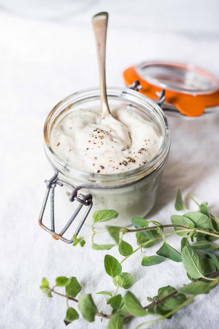 Vegan Ranch dip in a jar with a spoon. 