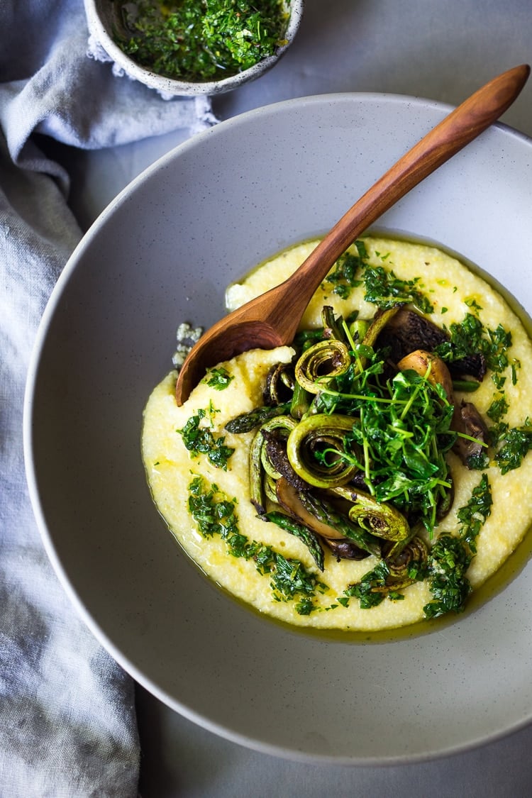 30 Vibrant Healthy Spring Recipes : Creamy Polenta with Spring Veggies and Gremolata - a flavorful healthy vegan meal featuring vibrant spring produce that can be made in under 30 minutes! Vegan & Gluten Free! #creamypolenta #vegan #springrecipes #asparagus #fiddleheadferns #morel #porcini #softpolenta #veganpolenta