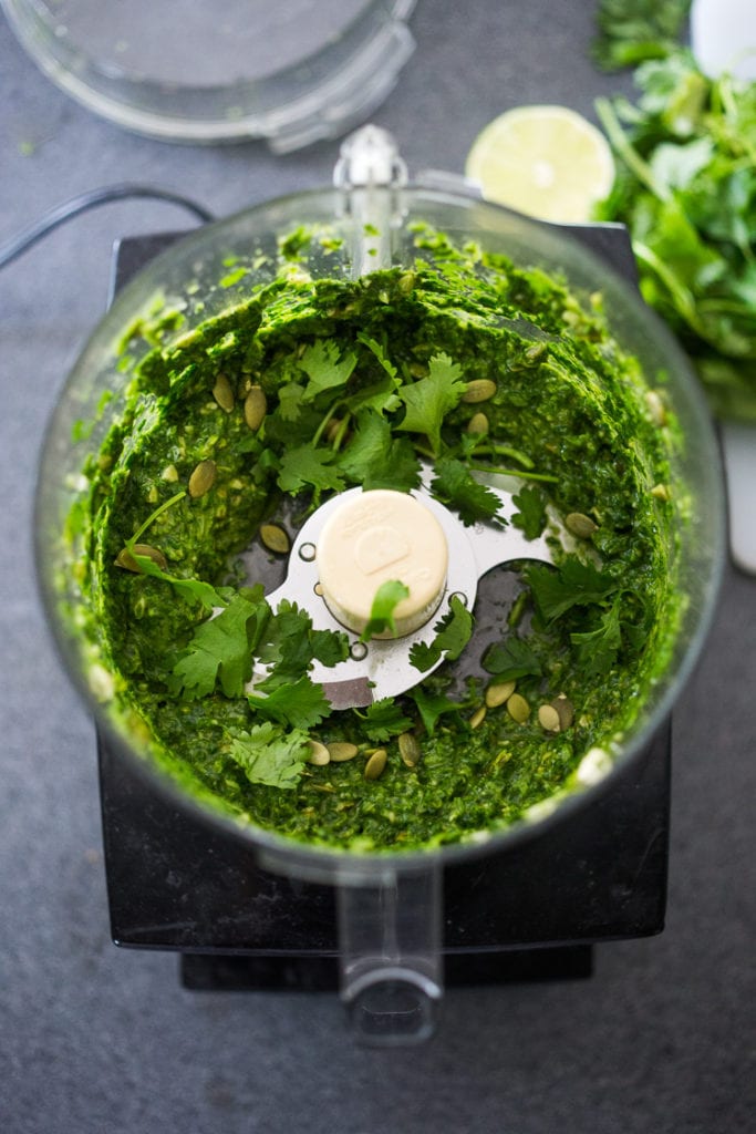 Making the cilantro pesto in a food processor. 