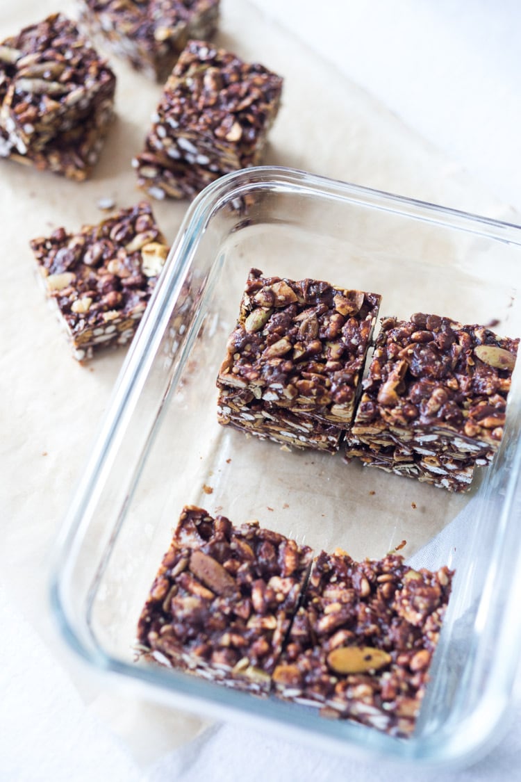 Healthy vegan Cacao Almond Crispy Treats are made with puffed 7 grain cereal, almond butter, found cacao powder and a boatload of  healthy omega 3-powered seeds- chia, sunflower and pumpkin. A delicious chocolatey fix, full of nutritious ingredients. #ricecrispytreats #cacao #almondbutter #vegan #healthy | www.feastingathome.com