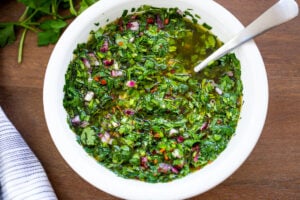 The best Chimichurri Sauce - an herby green sauce from Argentina that will quickly become your new favorite condiment. Make it in 10 minutes!
