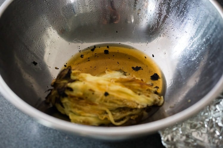 collecting the smoky juices from the eggplant.