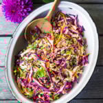 Easy Crunchy Asian Slaw- a simple vegan slaw with the BEST SLAW DRESSING EVER that can be made ahead! Serve this alongside fish, tofu, or chicken or stuffed into tacos, topped onto burgers, or added to buddha bowls. A great way to add more veggies into your everyday meals. #slaw #asianslaw #veganslaw #easyslaw #tacoslaw