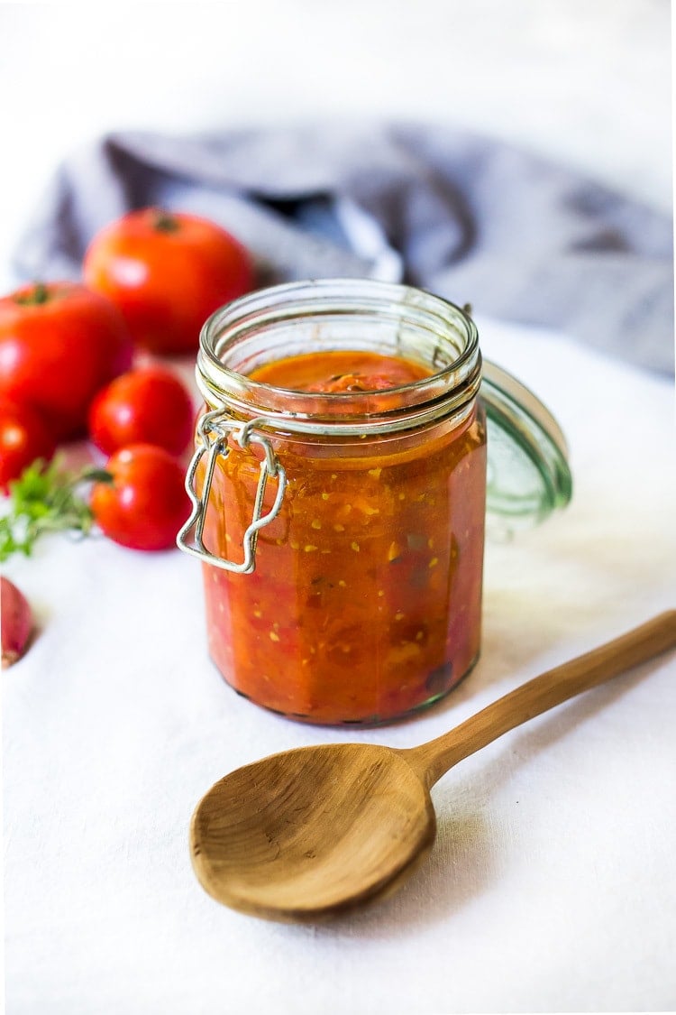 An easy recipe for Roasted Tomato Sauce made with fresh summer tomatoes, garlic and herbs. Extend summer's harvest into winter- can be made ahead and frozen or canned.