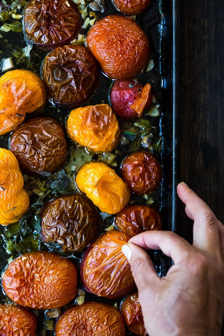 An easy recipe for Roasted Tomato Sauce made with fresh summer tomatoes, garlic and herbs. Extend summer's harvest into winter- can be made ahead and frozen or canned.