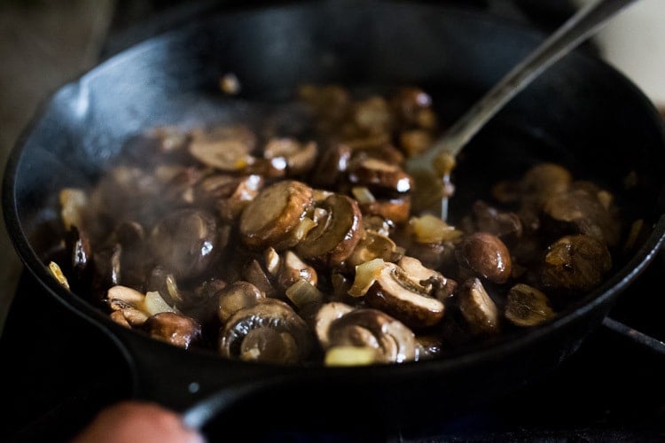 mushrooms cooking in a skillet.