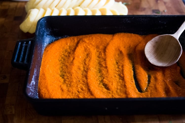 Assemebling the lasagna- layer of sauce in baking dish.