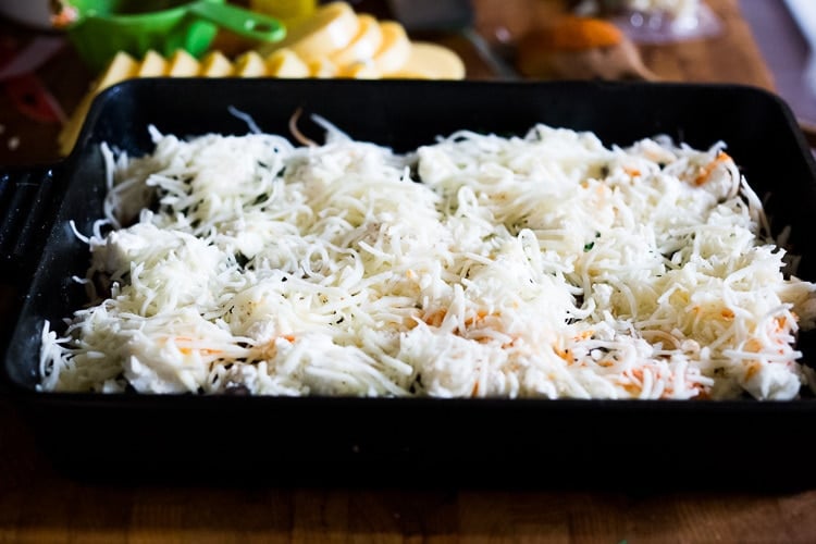 assembling the lasagna - adding the cheese.